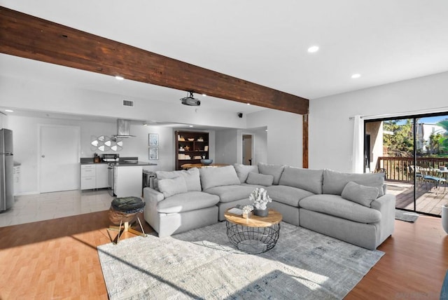 living room with hardwood / wood-style floors and beam ceiling