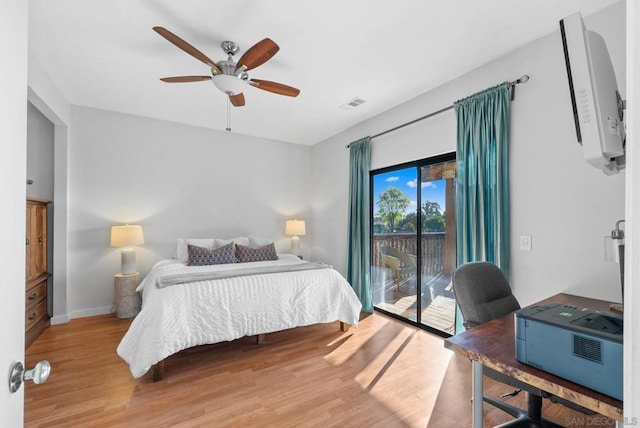 bedroom with hardwood / wood-style floors, access to exterior, and ceiling fan