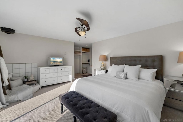 carpeted bedroom with ceiling fan and a closet