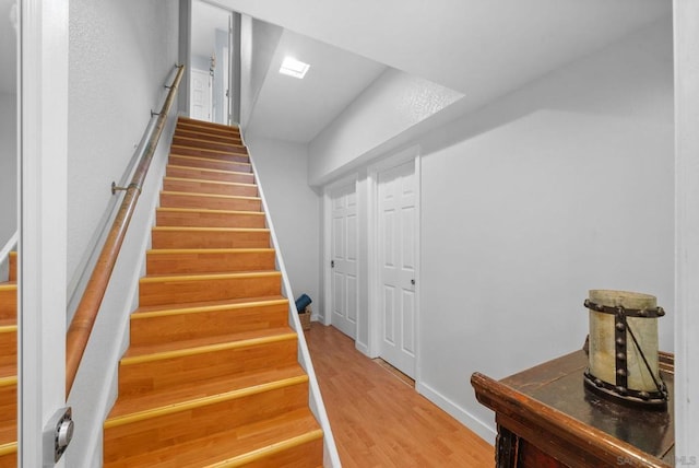 stairs with wood-type flooring