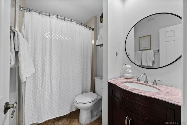 bathroom featuring vanity, tile patterned flooring, and toilet