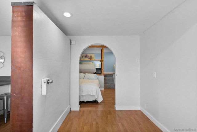 hallway with light hardwood / wood-style floors