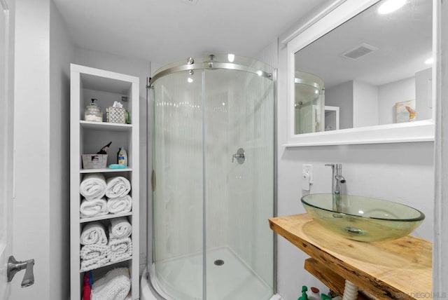 bathroom with sink and an enclosed shower