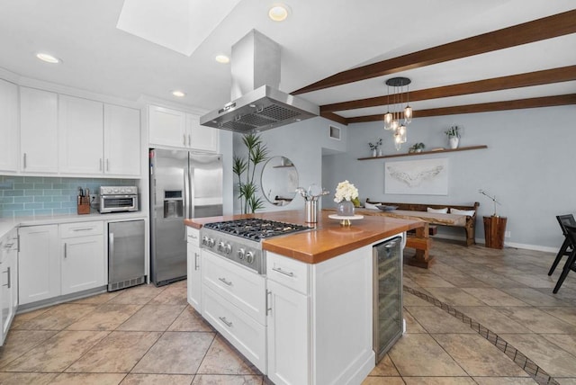 kitchen featuring white cabinetry, stainless steel appliances, extractor fan, and hanging light fixtures