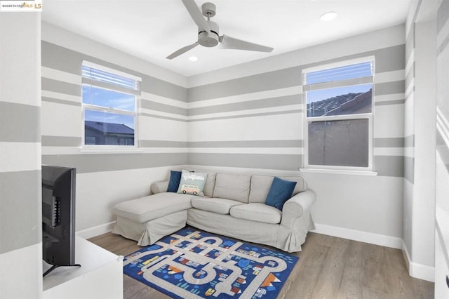 living room featuring ceiling fan and light hardwood / wood-style floors