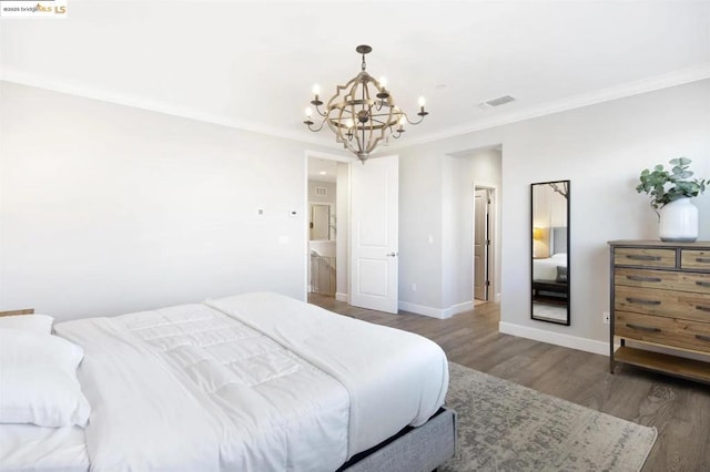 bedroom with dark hardwood / wood-style flooring, crown molding, and a notable chandelier