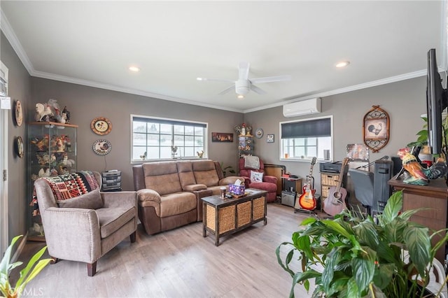 living room with ceiling fan, a wall mounted AC, ornamental molding, and light hardwood / wood-style floors