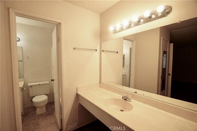 bathroom with toilet and vanity