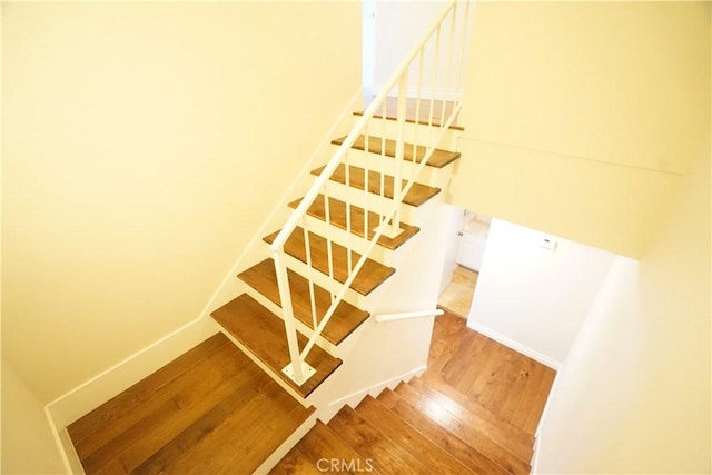 stairs with hardwood / wood-style floors