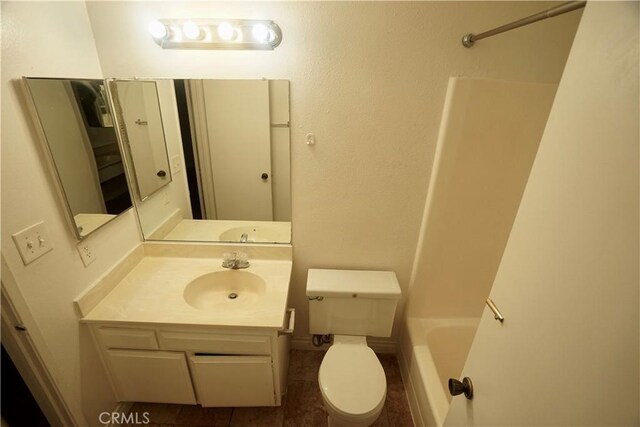 bathroom featuring toilet, vanity, and tile patterned floors