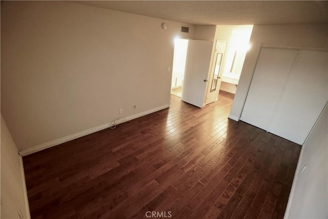 unfurnished room featuring dark hardwood / wood-style flooring