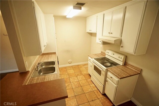 kitchen with light tile patterned floors, white cabinetry, white electric range oven, and sink