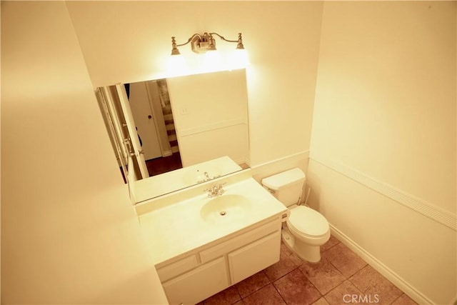 bathroom featuring toilet and vanity