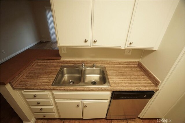 kitchen with sink, white cabinetry, and dishwasher