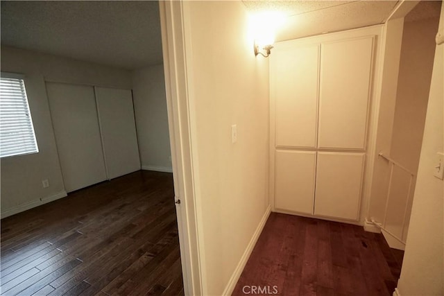 hall with dark hardwood / wood-style flooring