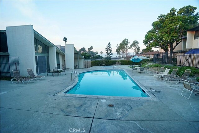 view of swimming pool with a patio