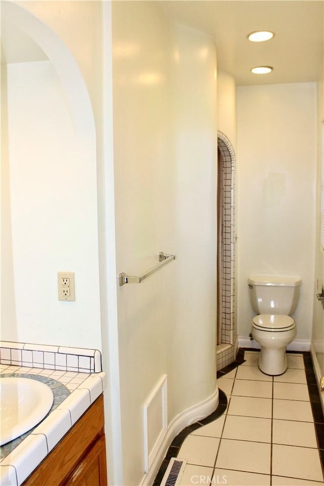 bathroom featuring toilet, tile patterned flooring, and vanity