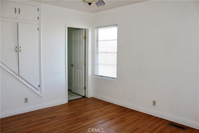 empty room featuring ceiling fan and hardwood / wood-style flooring