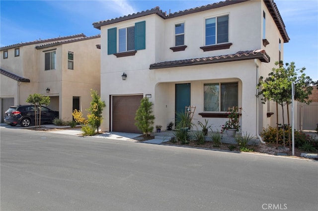 mediterranean / spanish-style home with a garage