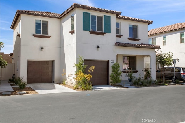 mediterranean / spanish home featuring a garage