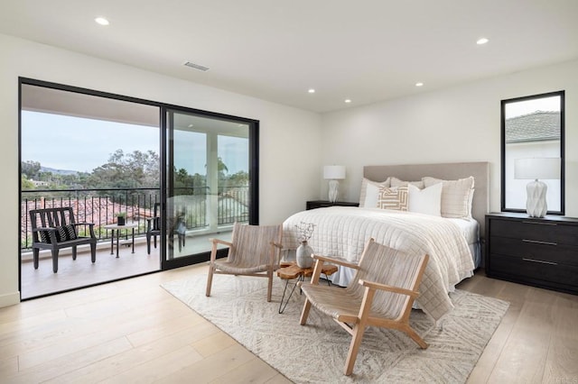 bedroom with access to exterior and light hardwood / wood-style flooring