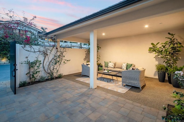 patio terrace at dusk featuring an outdoor hangout area