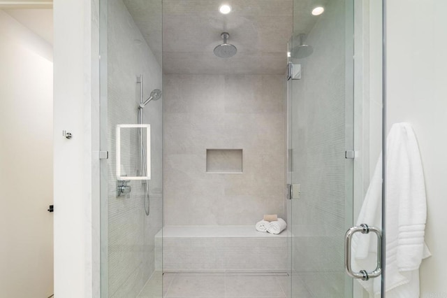 bathroom featuring a shower with door and tile patterned flooring