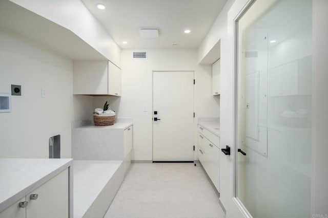 laundry area with cabinets