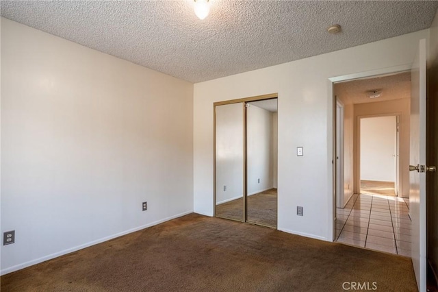 unfurnished bedroom with a closet, a textured ceiling, and carpet flooring