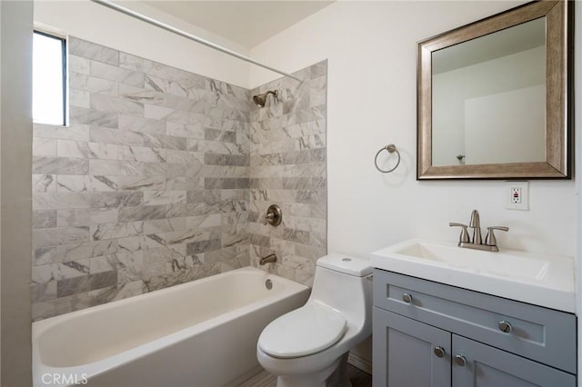 full bathroom featuring toilet, tiled shower / bath combo, and vanity