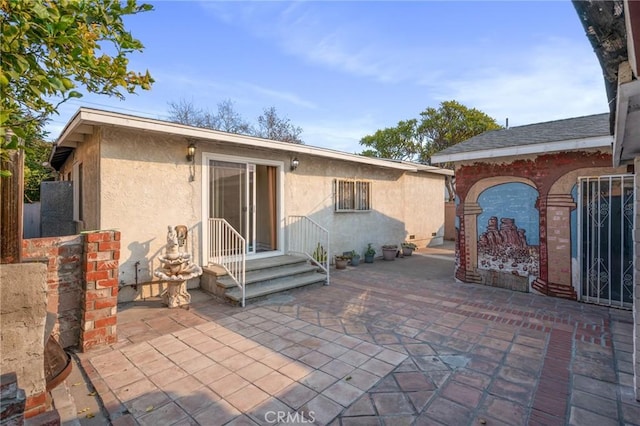 back of house with a patio