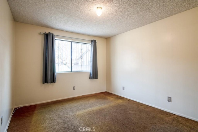 carpeted empty room with a textured ceiling