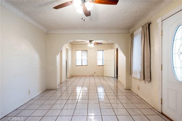 unfurnished room featuring a textured ceiling and ceiling fan