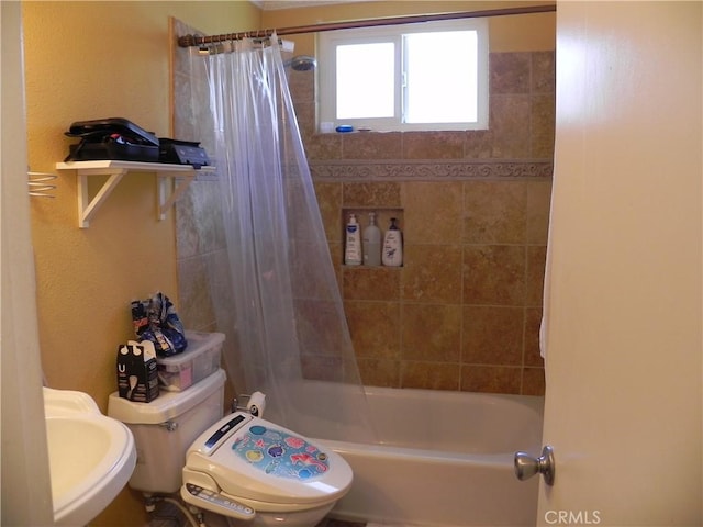 full bathroom featuring toilet, sink, and shower / bath combo with shower curtain