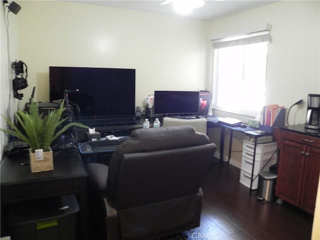 home office with dark hardwood / wood-style floors and ceiling fan