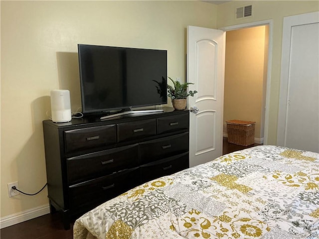 bedroom with dark hardwood / wood-style floors