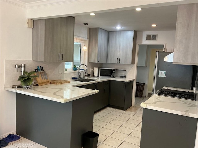 kitchen with light tile patterned flooring, stainless steel fridge, kitchen peninsula, and sink