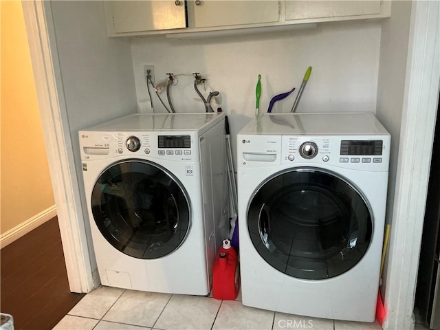 laundry area with light tile patterned flooring and independent washer and dryer