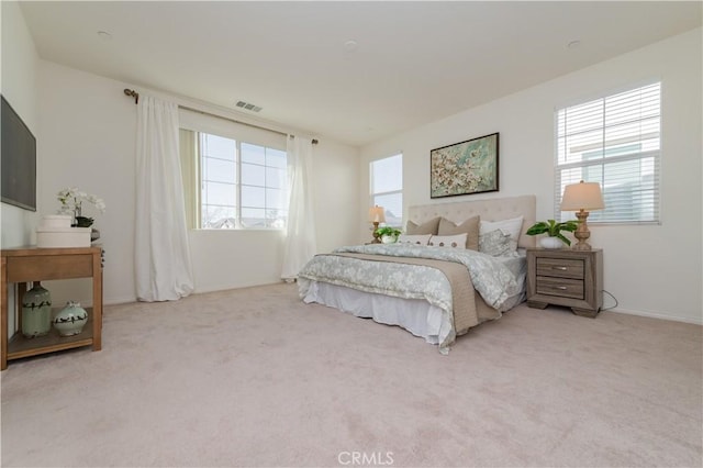 bedroom featuring light carpet