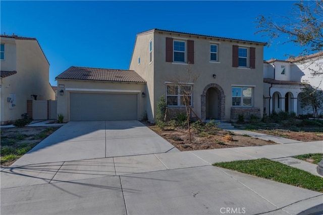 mediterranean / spanish-style house with a garage