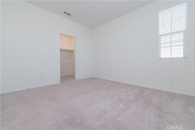 unfurnished room with light colored carpet