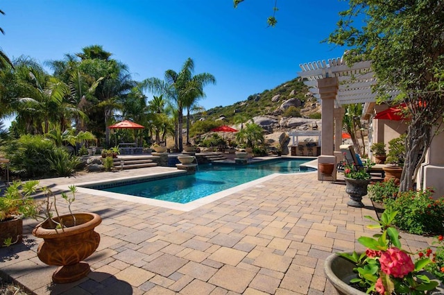 view of swimming pool featuring a pergola and a patio