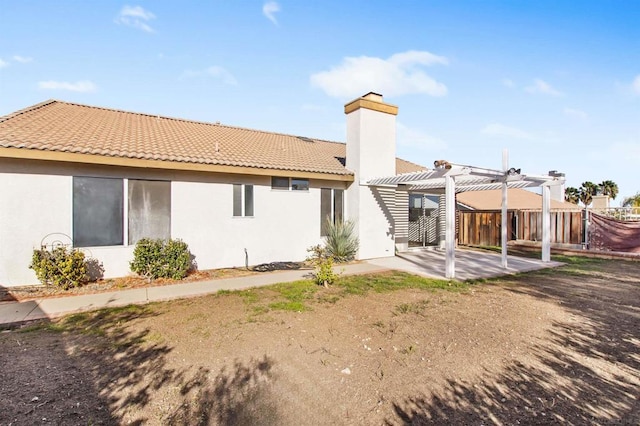 back of house with a patio area and a pergola