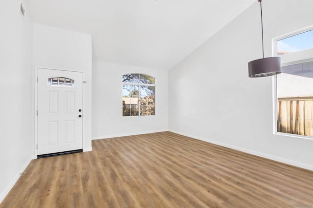 interior space featuring high vaulted ceiling and hardwood / wood-style floors