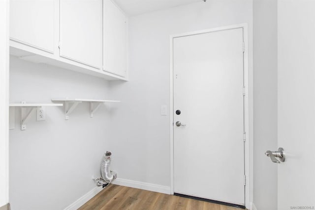 laundry room with cabinets and light wood-type flooring