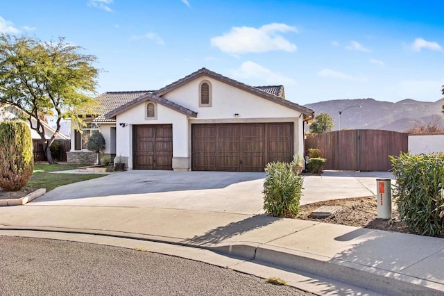 view of front of home with a garage and a mountain view