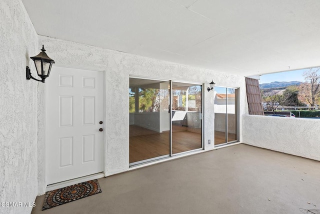 entrance to property with a balcony and a mountain view