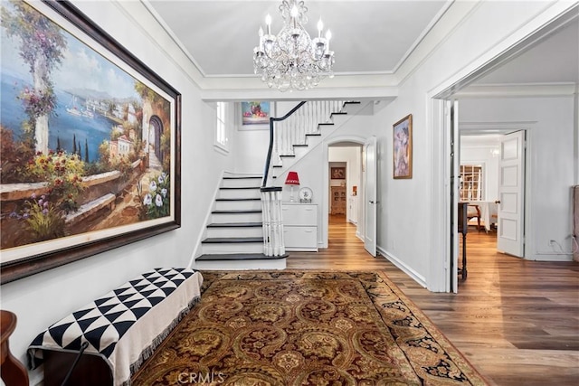 interior space featuring wood-type flooring, crown molding, and a chandelier