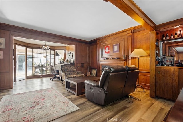 living room featuring light hardwood / wood-style floors, wood walls, and beamed ceiling