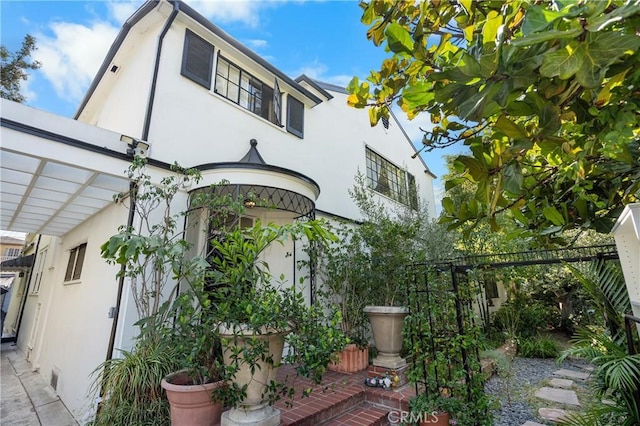 view of home's exterior with a pergola